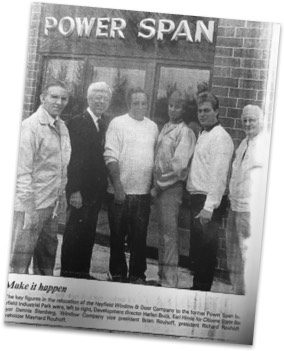 Newspaper clipping of an image of the leadership team standing in front of our newly expanded space